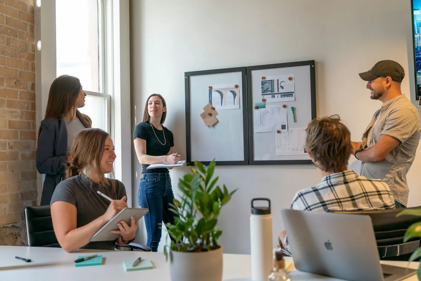 Team planning a project at a pinboard in a bright office